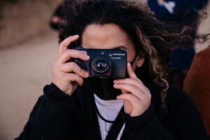 person holding a camera to their face