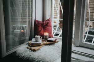 candle and coffee beside window