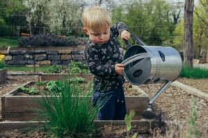 kid gardening watering crops